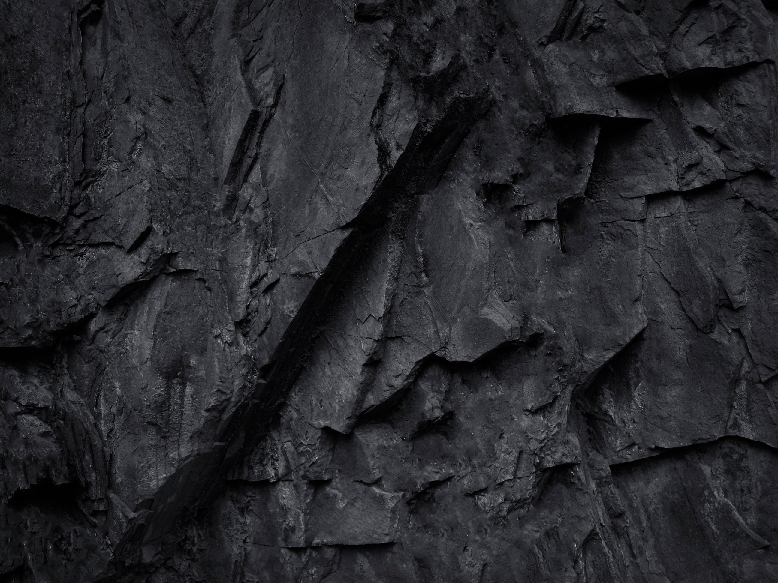 Black and white background. Rock testure. Black grnage background. Mountain texture. Close-up. Volumetric stone background.